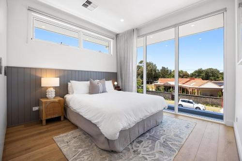 a bedroom with a large bed and a large window at Cove at Palmstone - 2BR, Parking, Wifi in Glenelg