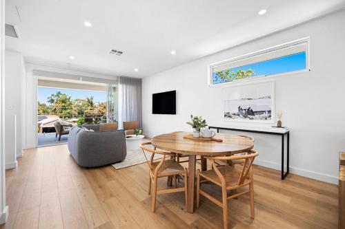 a living room with a table and a chair at Cove at Palmstone - 2BR, Parking, Wifi in Glenelg