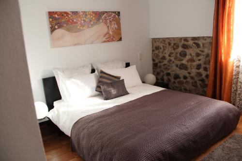 a bedroom with a large bed with white sheets and pillows at Finca Seguró in Sella