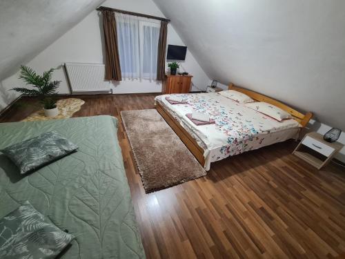 a small bedroom with two beds and a staircase at Cabana Busuioc in Colibiţa