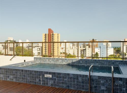 a swimming pool on the roof of a building at Feel Home - Flat Romântico com Piscina no Rooftop in Cabedelo