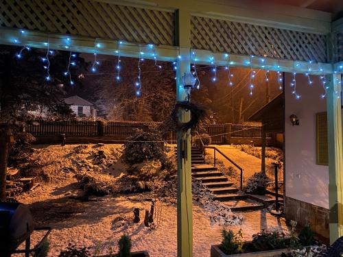 a porch with lights and a clock on a house at Liget Villa Szentendre in Szentendre
