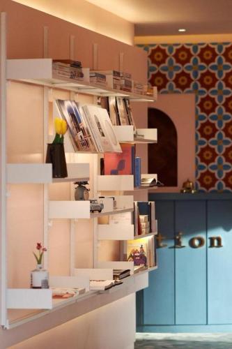 a book shelf filled with books in a room at Plain Hotel in Chuncheon