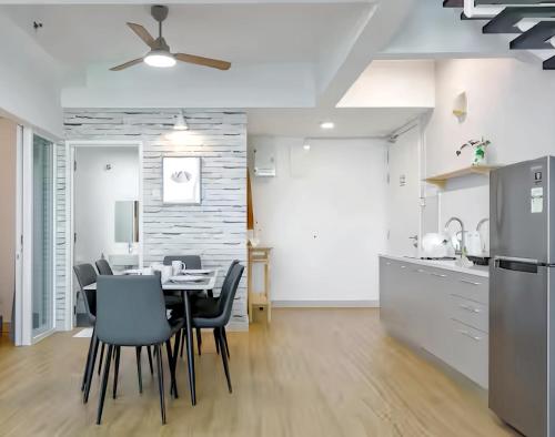 a kitchen and dining room with a table and chairs at Maritime Suites Penang in Jelutong