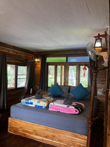 a bed in a room with some pillows on it at Baan IngDao MaekamPong Chiang Mai in Ban Pok Nai