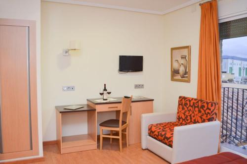 a room with a desk and a chair and a desk at Hotel Malena in Caravaca de la Cruz