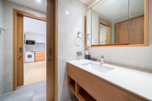 a bathroom with a sink and a mirror at Laguna Beachside Residents in Phuket