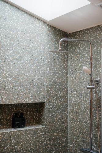 a bathroom with a shower with a mosaic wall at Baan Chaweng Beach Resort & Spa - SHA Extra Plus in Chaweng