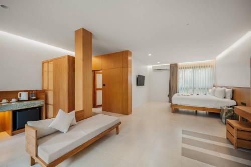 a living room with two beds and a couch at Baan Chaweng Beach Resort & Spa - SHA Extra Plus in Chaweng