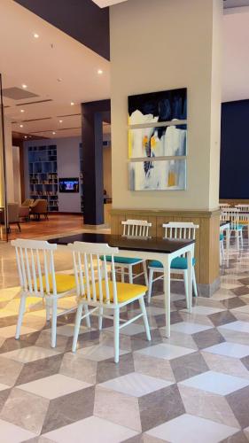 a dining room with a table and chairs at The Royal Suites Gomti Nagar Lucknow in Lucknow