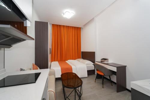 a hotel room with a bed and a desk and a kitchen at Banyueli Hotel in Shanghai