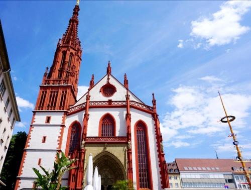 a large church with a steeple on top of it at Greifensteiner Hof in Würzburg