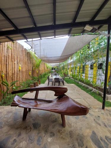 a wooden bench sitting inside of a building at BC Lodge in Puerto Princesa City