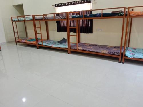 a group of bunk beds in a room at Madhura Agro Tourism in Wai