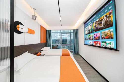 a hotel room with a large tv on the wall at Banyueli Hotel in Shanghai