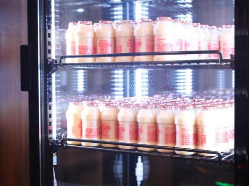 a refrigerator filled with lots of bottles of milk at Dormy Inn Wakkanai in Wakkanai