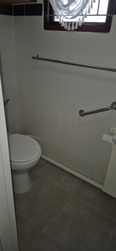 a bathroom with a toilet and a window at At lilac, Jeffreys Bay, cottage for 2 in Jeffreys Bay