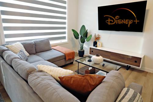 a living room with a couch and a table at Downtown 3 Queen Beds, AC, Double Garage, Disney in Edmonton