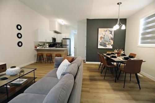 a living room with a couch and a table at Downtown 3 Queen Beds, AC, Double Garage, Disney in Edmonton