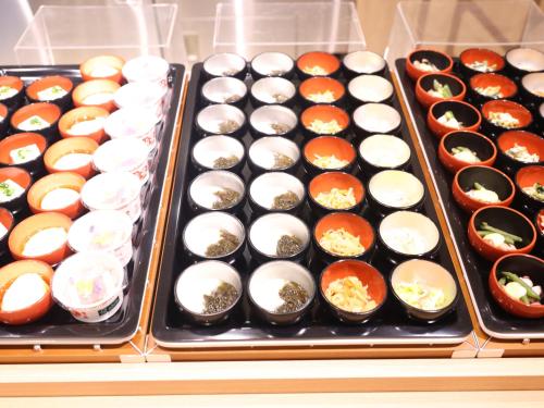 a display case filled with lots of different types of sushi at Dormy Inn Wakkanai in Wakkanai