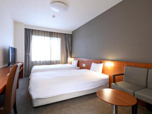 Cama ou camas em um quarto em Dormy Inn Wakkanai