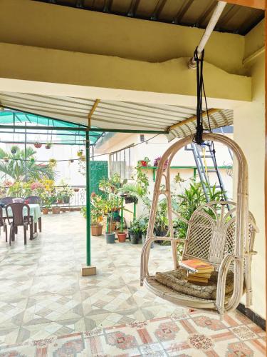 a swing hanging from the ceiling of a patio at Tulip Inn - 2BHK Rooftop AC Near Kamakhya in Guwahati