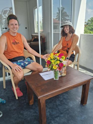 a man and a woman sitting around a coffee table at RKO Villa27 - Unawatuna in Habaraduwa