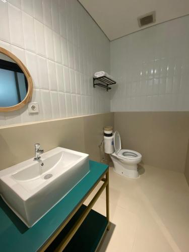 a bathroom with a sink and a toilet at Agung Guest House by RF in Timuran
