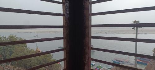 a view of the water from a window at Pushkarni Home Stay in Varanasi