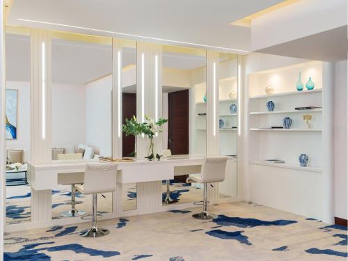 a room with a table with chairs and a mirror at Fairmont Bab Al Bahr in Abu Dhabi