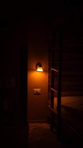 a dark room with a light on the wall at Németh Resort in Sovata
