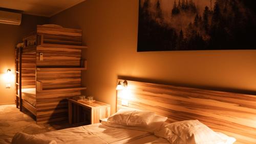 a bedroom with a bed with a wooden head board at Németh Resort in Sovata