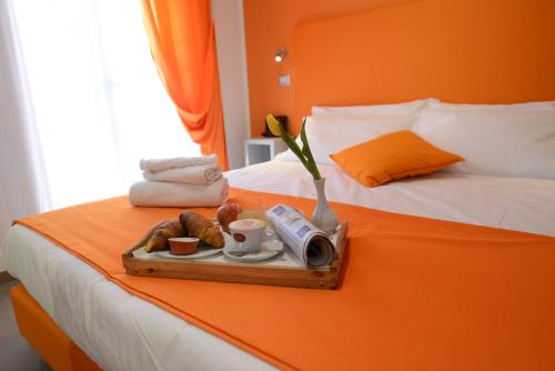 Posteľ alebo postele v izbe v ubytovaní Hotel Nuova Orchidea