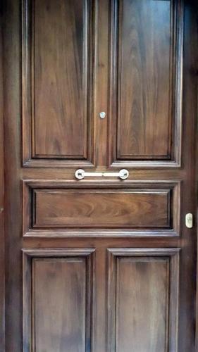 a wooden door with ajar panels on it at Marietta's House in Rhodes Town