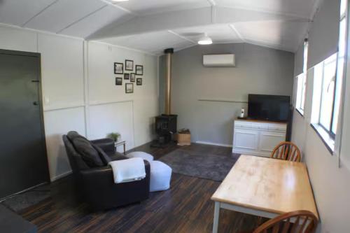 a living room with a couch and a table at The Old School House BnB in Kybunga