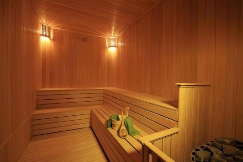 a sauna with wood paneling and lights on the walls at Maritime Suites Penang in Jelutong