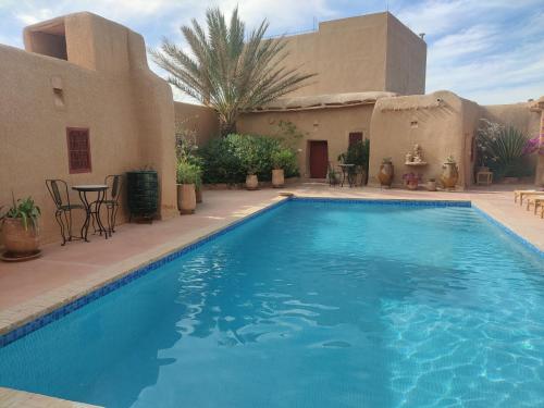 a swimming pool in the middle of a house at Riad ysabil in Amersal