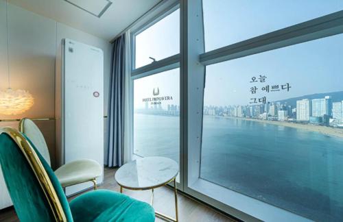 a room with a large window with a view of the ocean at Gwangalli Hotel primavera in Busan in Busan
