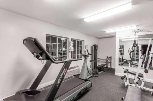 a gym with tread machines and a treadmill at Ramada by Wyndham Oceanside in Oceanside