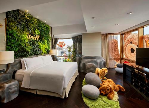 a bedroom with a white bed and a green wall at Waldorf Astoria Beijing in Beijing