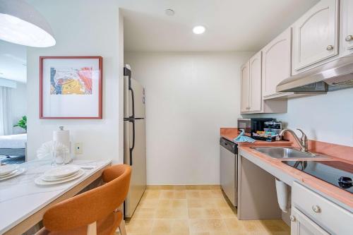 a kitchen with white cabinets and a counter top at Homewood Suites by Hilton East Rutherford - Meadowlands, NJ in East Rutherford
