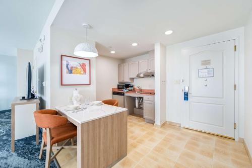 a kitchen with a table and chairs in a room at Homewood Suites by Hilton East Rutherford - Meadowlands, NJ in East Rutherford