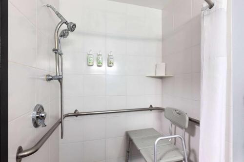 a bathroom with a shower with a bench in it at La Quinta by Wyndham Sevierville / Kodak in Sevierville