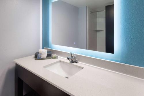 a bathroom with a sink and a large mirror at La Quinta by Wyndham Sevierville / Kodak in Sevierville