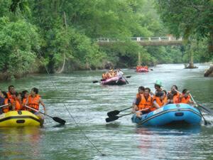 a group of people in rafts in a river at Kaengkrachan River Hut in Kaeng Krachan