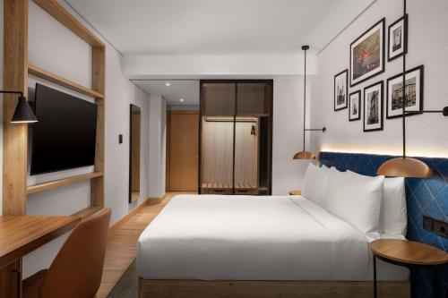 a hotel room with a bed and a desk at Hilton Garden Inn Baku in Baku
