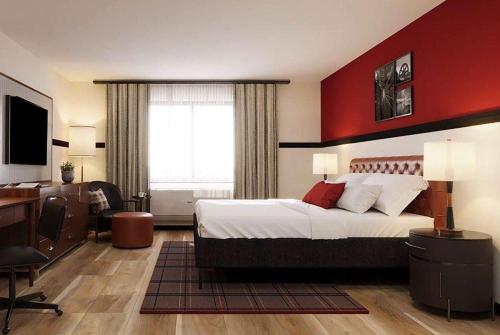 a hotel room with a large bed and a desk at Hotel Vervana, Trademark Collection by Wyndham in Bennington