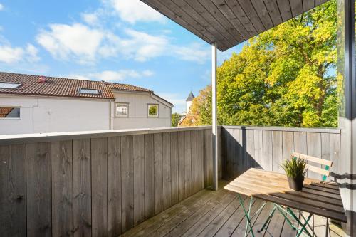 a balcony with a wooden fence and a wooden bench at Architectural Studio I Private Balcony I NEW 2021 in Bergen