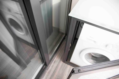 a washing machine in a bathroom next to a window at Flat 1, spacious 3 bedroom near Beaches and Countryside in Mġarr