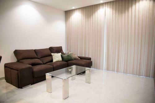 a living room with a couch and a glass table at Flat 1, spacious 3 bedroom near Beaches and Countryside in Mġarr